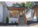 Charming home featuring a covered porch with wooden railings, and well manicured landscaping, creating a welcoming curb appeal at 13 St Augustine, Raleigh, NC 27610