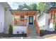Charming home featuring a covered porch with wooden railings, and well manicured landscaping, creating a welcoming curb appeal at 13 St Augustine, Raleigh, NC 27610
