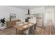 Cozy dining area with an adjoining kitchen, a wooden dining table, and stylish furnishings for comfortable living at 13 St Augustine, Raleigh, NC 27610