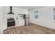 Functional kitchen equipped with stainless steel appliances, white cabinetry, and wood-look flooring, offering modern convenience at 13 St Augustine, Raleigh, NC 27610