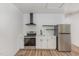 Modern kitchen featuring stainless steel appliances, white cabinetry, and sleek black accents at 13 St Augustine, Raleigh, NC 27610