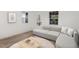 Stylish living room with modern furniture, a neutral color palette, wood-look floors and ample natural light at 13 St Augustine, Raleigh, NC 27610