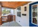 Inviting porch with wood-paneled ceiling, modern railing, and sleek mailbox, offering a stylish welcome to guests and residents at 13 St Augustine, Raleigh, NC 27610