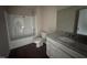 Well-lit bathroom with a shower-tub combo and granite-topped vanity offering functionality at 131 Wilderness Trl, Smithfield, NC 27577