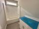 Bathroom featuring a tub/shower combo, tiled floors, and a vanity with blue protective film at 139 Red River Dr, Selma, NC 27576