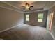 Bright, spacious bedroom with a tray ceiling, large windows, and neutral carpet at 139 Red River Dr, Selma, NC 27576