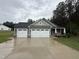 Charming single-Gathering home featuring a three-car garage and manicured lawn on a cloudy day at 139 Red River Dr, Selma, NC 27576