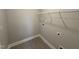 A compact laundry room with tiled floors, shelving for storage, and utility connections at 139 Red River Dr, Selma, NC 27576