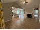 Spacious living room featuring hardwood floors, a fireplace, and an open layout into the kitchen at 139 Red River Dr, Selma, NC 27576