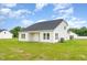 Beautiful backyard with fresh grass and white siding, perfect for outdoor activities and gatherings at 141 Trescott St, Smithfield, NC 27577
