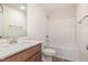 Bright bathroom featuring a modern sink, vanity, and bathtub with shower; perfect for relaxation at 141 Trescott St, Smithfield, NC 27577