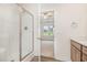 Bright bathroom featuring a shower, wood-grain cabinets, and a view of a bedroom at 141 Trescott St, Smithfield, NC 27577