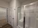 Modern bathroom with glass-enclosed shower and access to a spacious walk-in closet for ample storage at 141 Trescott St, Smithfield, NC 27577