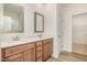 Bathroom vanity with double sinks, quartz counters, and wood-grain cabinets at 141 Trescott St, Smithfield, NC 27577