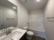 Bright bathroom with large mirror and shower-tub combo at 141 Trescott St, Smithfield, NC 27577