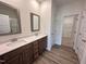 Elegant primary bathroom featuring a double vanity, sleek countertops, and a spacious walk-in shower, combining style and functionality at 141 Trescott St, Smithfield, NC 27577