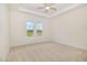 Bright bedroom featuring a tray ceiling and view of the outdoors through two windows at 141 Trescott St, Smithfield, NC 27577