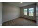 Cozy bedroom with carpeted floors and double windows at 141 Trescott St, Smithfield, NC 27577