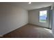 Well-lit bedroom with carpet flooring and a large window at 141 Trescott St, Smithfield, NC 27577