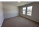Bright bedroom with carpet flooring and two large windows at 141 Trescott St, Smithfield, NC 27577