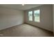 Cozy bedroom with carpeted floors and double windows at 141 Trescott St, Smithfield, NC 27577