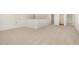 Spacious bonus room with neutral carpet and view of hall with bathroom, ideal for recreation or entertainment at 141 Trescott St, Smithfield, NC 27577