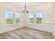 Bright dining area with ample natural light, wainscoting, and a modern chandelier at 141 Trescott St, Smithfield, NC 27577