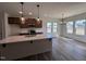Gourmet kitchen with quartz countertops, pendant lighting, stainless appliances, and seamless flow into the dining area at 141 Trescott St, Smithfield, NC 27577