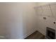 Functional laundry room with shelving and utility connections, providing convenience and storage at 141 Trescott St, Smithfield, NC 27577
