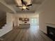 Elegant living space with fireplace, coffered ceilings, and an open view of the contemporary kitchen at 141 Trescott St, Smithfield, NC 27577