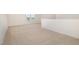 Large loft area with neutral walls and carpet and windows to let in natural light at 141 Trescott St, Smithfield, NC 27577