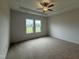 Serene bedroom retreat with coffered ceilings, plush carpeting, and bright windows overlooking the yard at 141 Trescott St, Smithfield, NC 27577