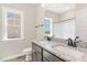 Bathroom featuring a double vanity with granite countertop, framed mirror, and natural light from a window at 143 Royal Ave, Selma, NC 27576