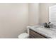 Half bathroom features granite countertop and dark wood vanity at 143 Royal Ave, Selma, NC 27576