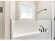 Bathroom features large white soaking tub, black fixtures and window view at 143 Royal Ave, Selma, NC 27576