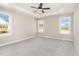 Spacious bedroom with tray ceiling, neutral paint, carpet flooring, and natural light at 143 Royal Ave, Selma, NC 27576