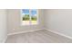 Bright bedroom with neutral paint, carpet, and a window that offers an inviting view of the outdoors at 143 Royal Ave, Selma, NC 27576