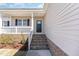 Home entrance featuring a brick stairway and covered porch at 143 Royal Ave, Selma, NC 27576