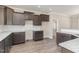Stylish kitchen showcasing gray cabinets, granite countertops, and herringbone backsplash at 143 Royal Ave, Selma, NC 27576