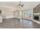 Inviting living space with a stone fireplace, large windows, and hardwood floors at 143 Royal Ave, Selma, NC 27576