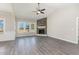 Bright living room featuring a stone fireplace, hardwood floors and large windows at 143 Royal Ave, Selma, NC 27576