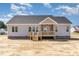 Rear exterior showcases a charming, covered wooden deck, and a well-constructed house at 143 Royal Ave, Selma, NC 27576
