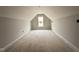Unfinished attic space ready to be transformed, featuring natural light from a window at 147 Tuskeegee Dr, Smithfield, NC 27577