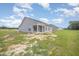 A view of the back of the house from the partially seeded lawn at 147 Tuskeegee Dr, Smithfield, NC 27577