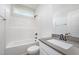 A modern bathroom featuring a tub with a shower and vanity with a light gray countertop at 147 Tuskeegee Dr, Smithfield, NC 27577
