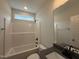 This is a well-lit bathroom featuring a shower and tub combo and a modern sink and faucet at 147 Tuskeegee Dr, Smithfield, NC 27577