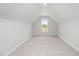 Carpeted bonus room or bedroom with white walls and a large window at 147 Tuskeegee Dr, Smithfield, NC 27577