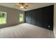 Bedroom featuring a dark wood-look accent wall and plush carpeting at 147 Tuskeegee Dr, Smithfield, NC 27577