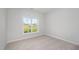 A cozy bedroom with a large window allowing natural light and plush carpeting at 147 Tuskeegee Dr, Smithfield, NC 27577