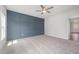 Large bedroom with carpet, a ceiling fan, and a gray paneled accent wall at 147 Tuskeegee Dr, Smithfield, NC 27577